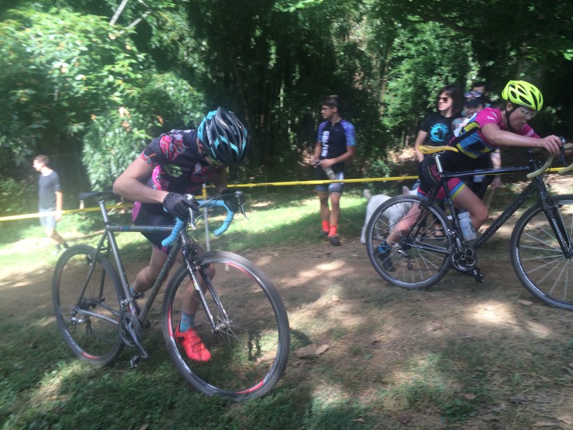 Two women running up cyclocross hill