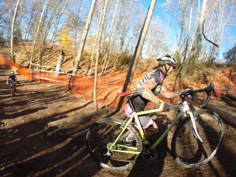 Woman carrying bicycle in a cyclocross race