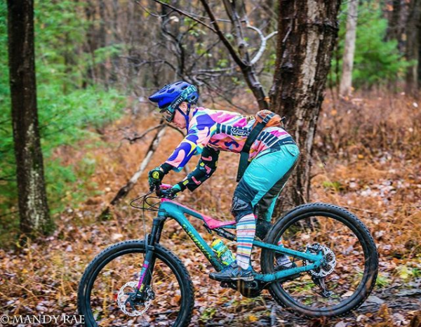 woman racing downhill mountain bike